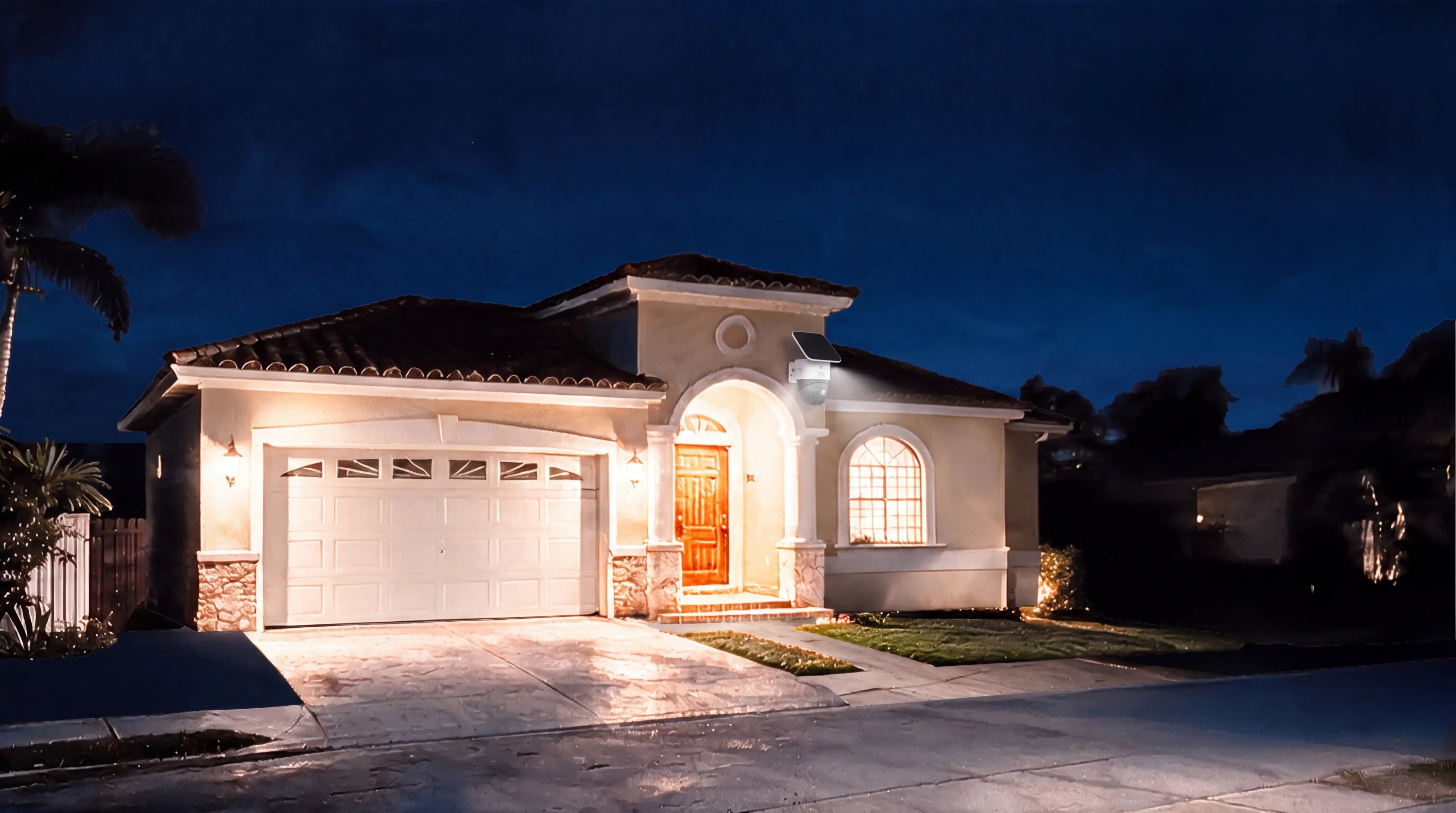 Suburban home at night with warm lights and a solar security camera with spotlight by the entrance